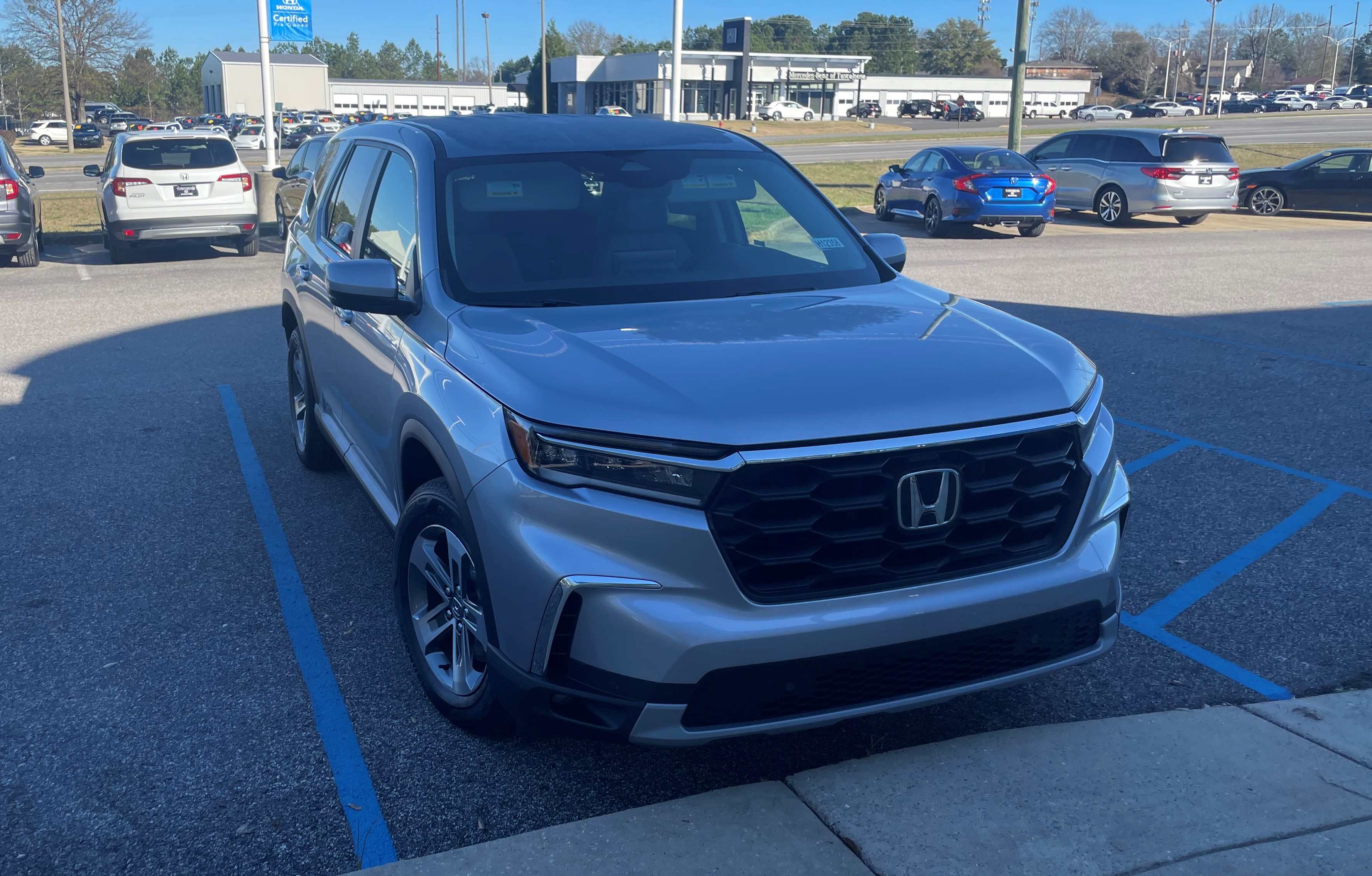 2023 Honda Pilot front three-quarter view illustrating its midsize three-row SUV size